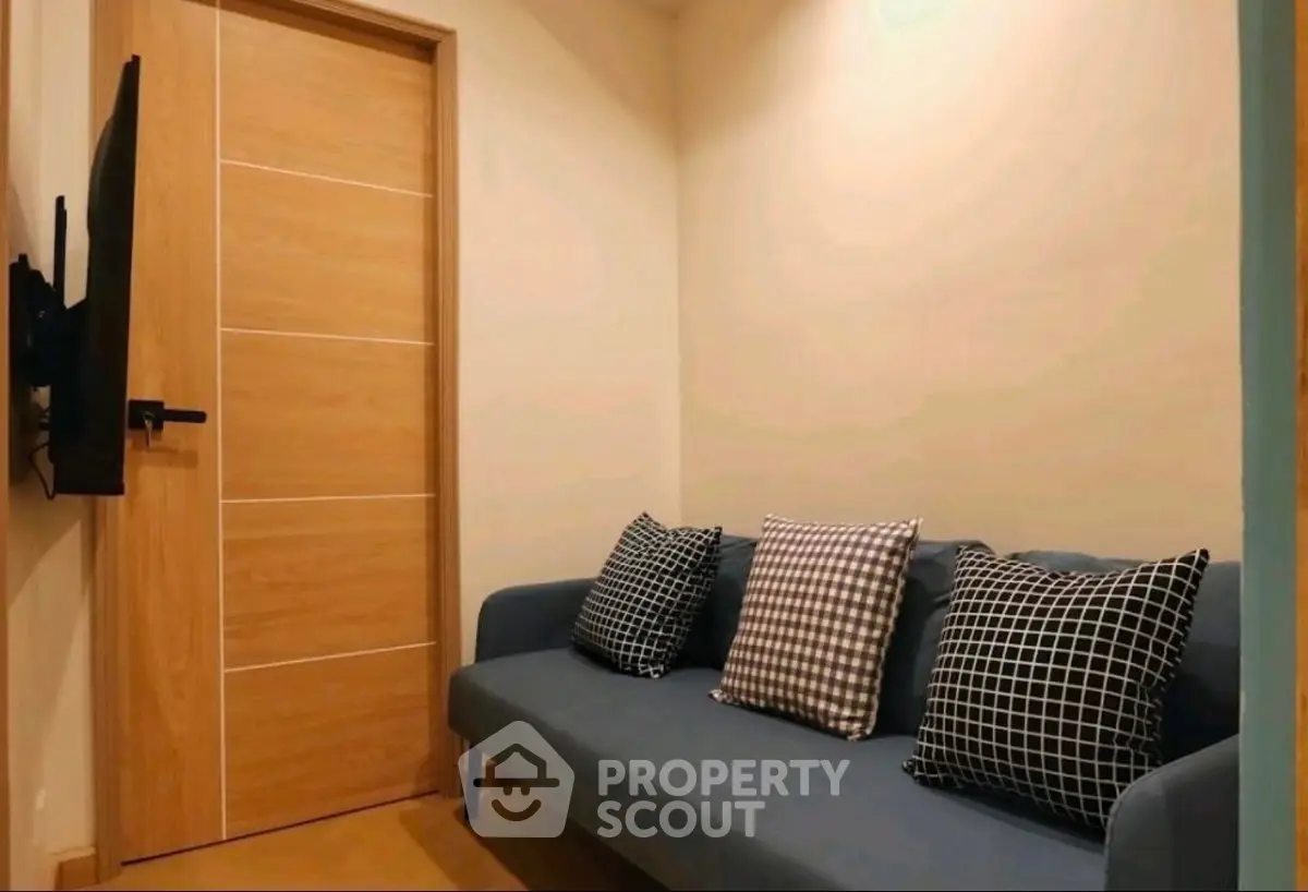 Cozy small living room with modern sofa and wall-mounted TV