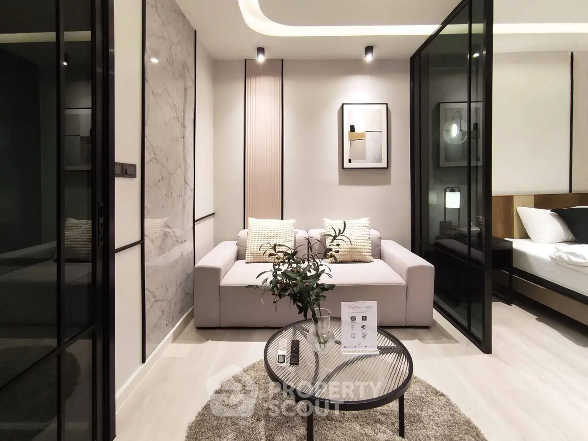 Modern living room with stylish decor and glass partitions in a luxury apartment.