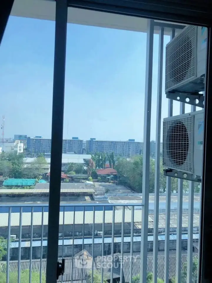 High-rise apartment view with air conditioning units and cityscape in the background.