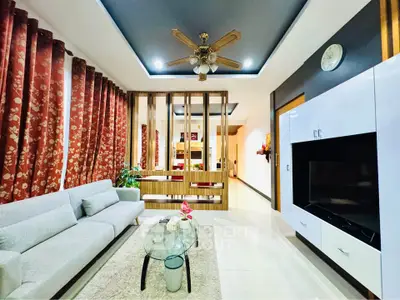 Spacious living room with modern decor and ceiling fan