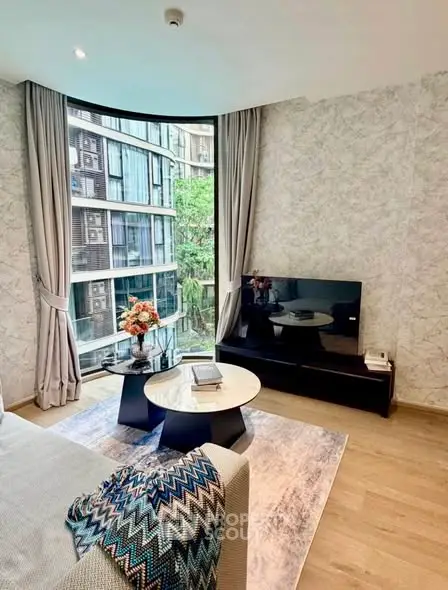 Modern living room with large windows and stylish decor in a luxury apartment.