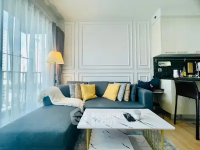 Modern living room with stylish decor and open kitchen layout in urban apartment.