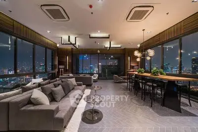 Luxurious modern living room with panoramic city views and stylish decor.