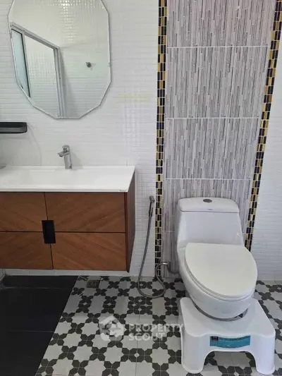 Modern bathroom with stylish vanity and patterned tile flooring