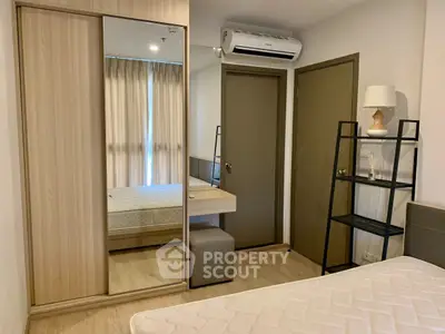 Modern bedroom with mirrored wardrobe and air conditioning in stylish apartment