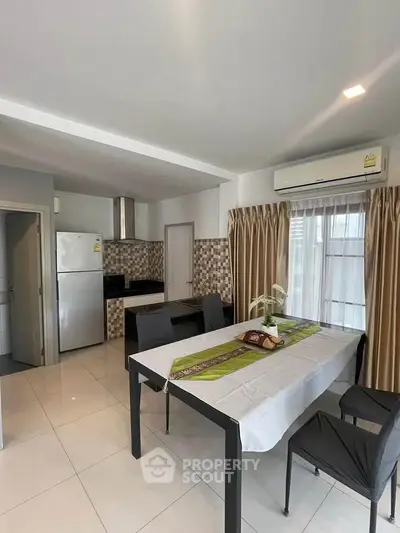 Modern kitchen and dining area with sleek appliances and stylish decor