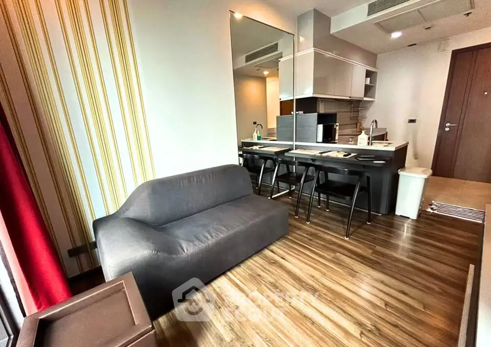 Modern open-layout living room with sleek kitchen and stylish furniture
