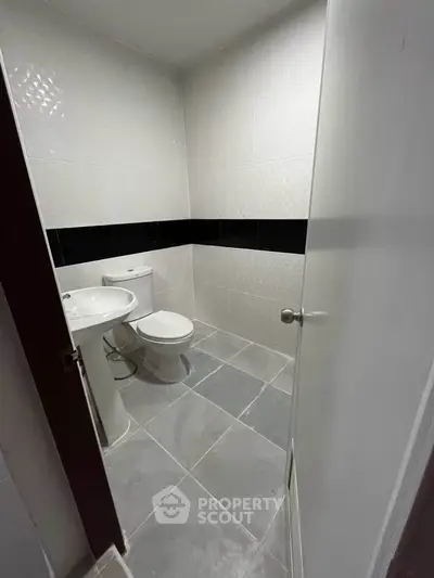 Modern bathroom with sleek white fixtures and minimalist design, perfect for contemporary living.
