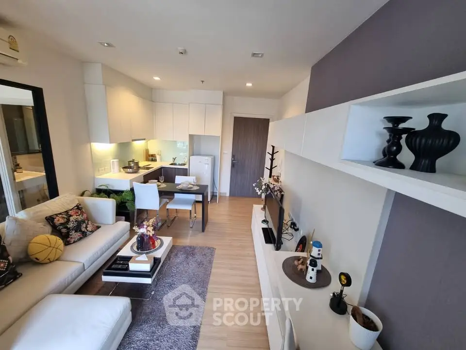 Modern living room with open kitchen layout and stylish decor