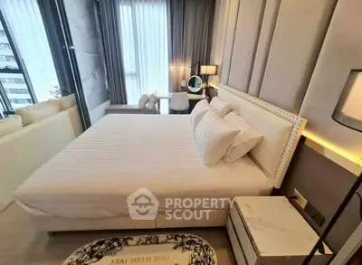 Luxurious bedroom with elegant decor and city view, featuring a plush bed and stylish furniture.