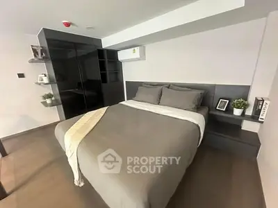 Modern bedroom with sleek design and cozy ambiance, featuring built-in storage and stylish decor.