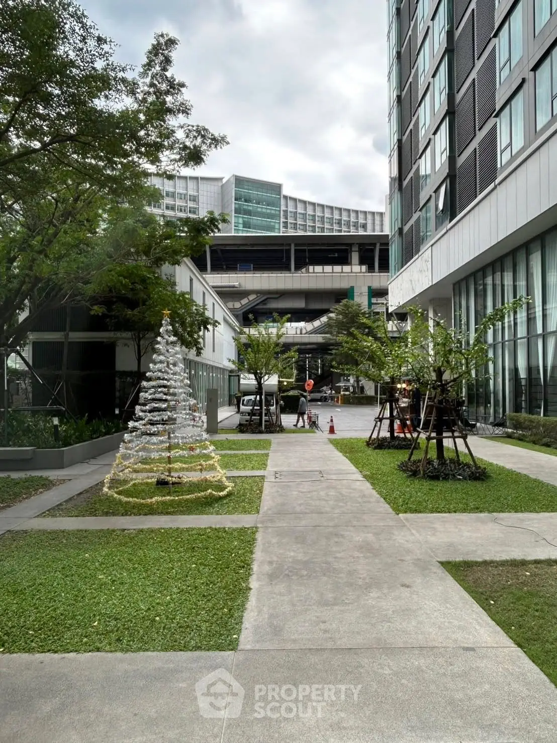 Modern building exterior with landscaped garden and festive decorations