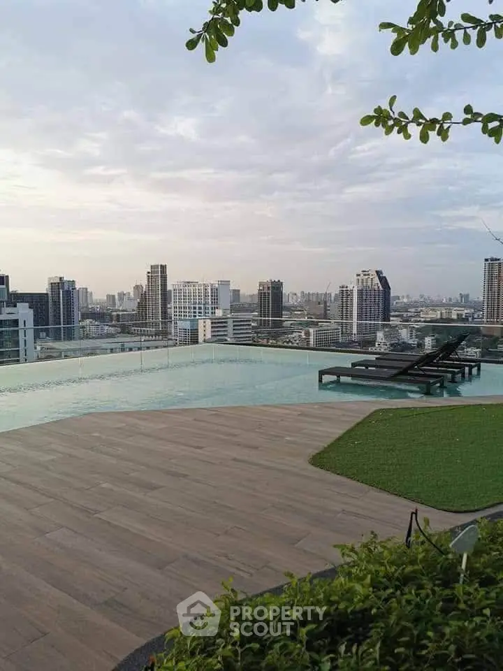 Stunning rooftop pool with panoramic city views and modern lounge chairs.