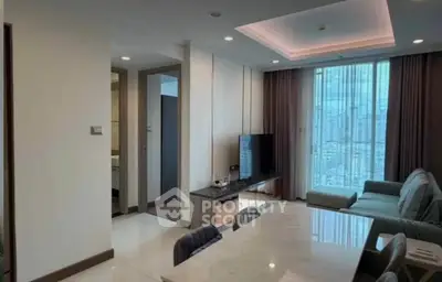 Modern living room with city view, featuring sleek furniture and ambient lighting.