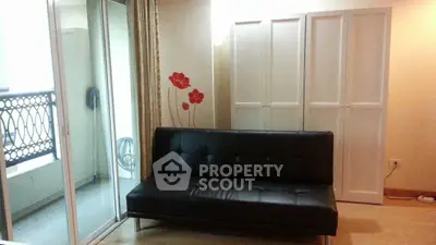 Stylish living room with modern black sofa and balcony access