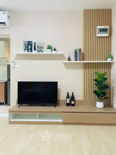 Modern living room with sleek TV stand, decorative shelves, and stylish wood paneling.