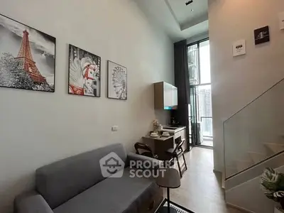 Modern living room with high ceiling and stylish decor in a contemporary apartment.