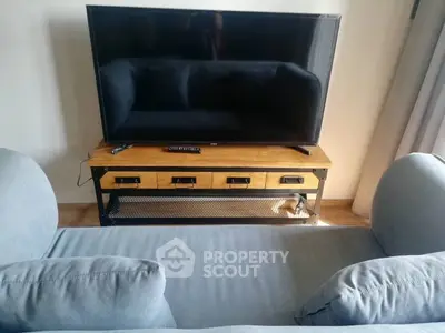 Modern living room with stylish TV stand and comfortable sofa