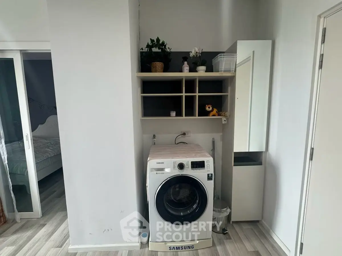 Modern laundry area with Samsung washing machine and storage shelves