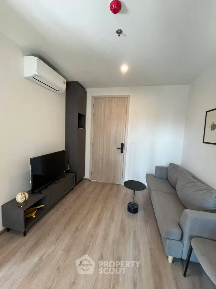 Modern living room with sleek furniture and air conditioning unit, perfect for cozy relaxation.