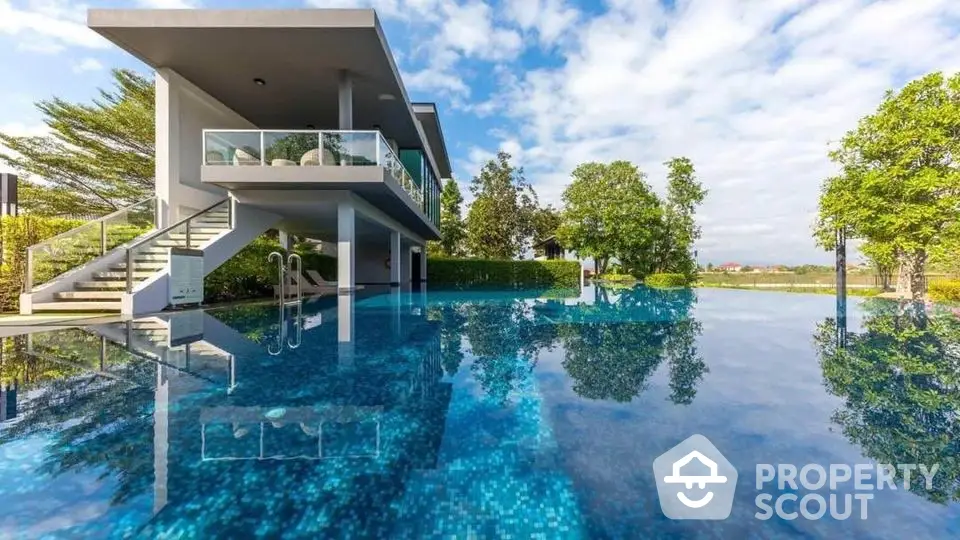 Luxurious modern house with stunning infinity pool and lush greenery