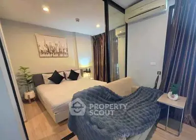 Cozy bedroom with modern decor and air conditioning in a stylish apartment.