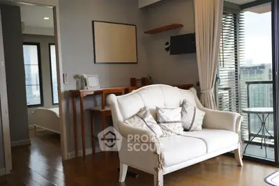 Elegant living room with cozy sofa and balcony view, perfect for relaxation and comfort.