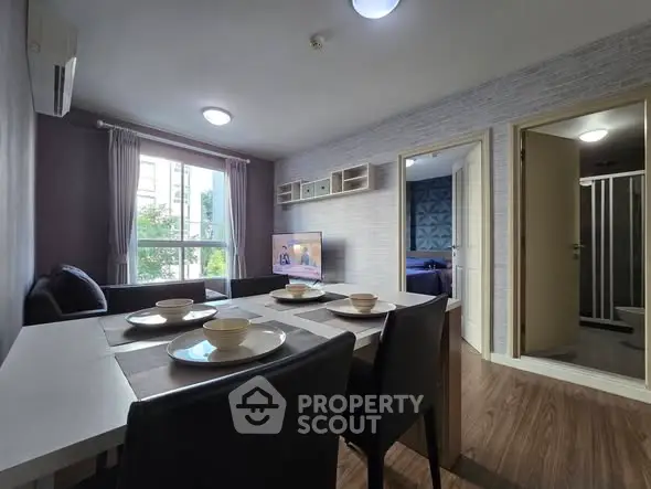 Modern living room with dining area and natural light