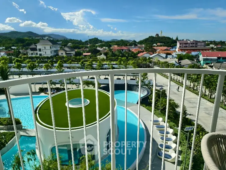 Stunning balcony view overlooking modern pool and lush landscape in luxury property.