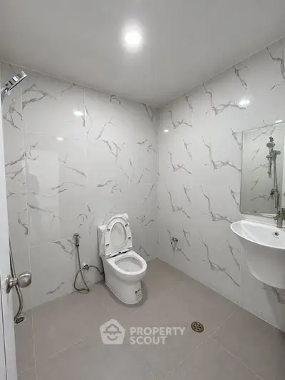 Modern bathroom with marble tiles and sleek fixtures