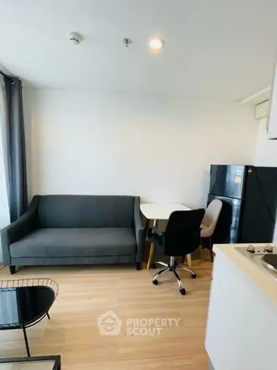 Modern living room with sleek furniture and open kitchen layout