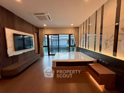 Luxurious modern bedroom with elegant wood flooring and large windows for natural light.