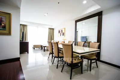Elegant dining area with modern furniture and large mirror in a bright apartment