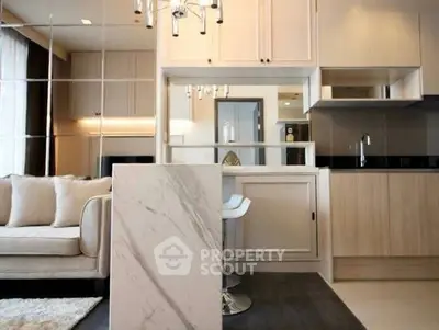 Modern open-layout kitchen with marble island and cozy living area