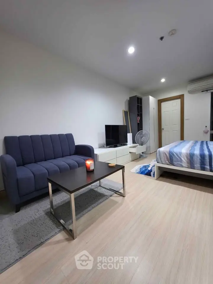 Modern studio apartment with cozy living area and stylish decor
