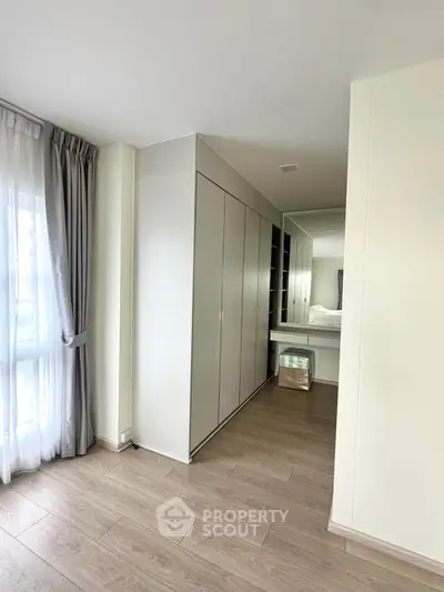 Spacious bedroom with elegant wardrobe and natural light