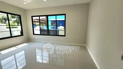Spacious empty room with large windows and glossy tiled floor, perfect for customization.