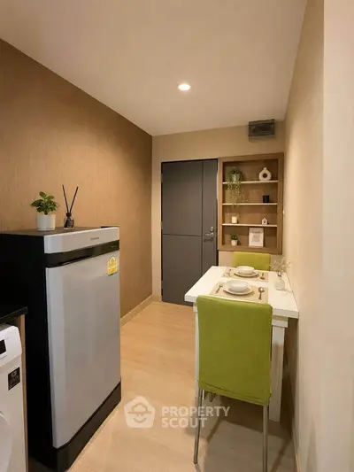 Cozy kitchen with modern appliances and stylish dining area in a compact layout.