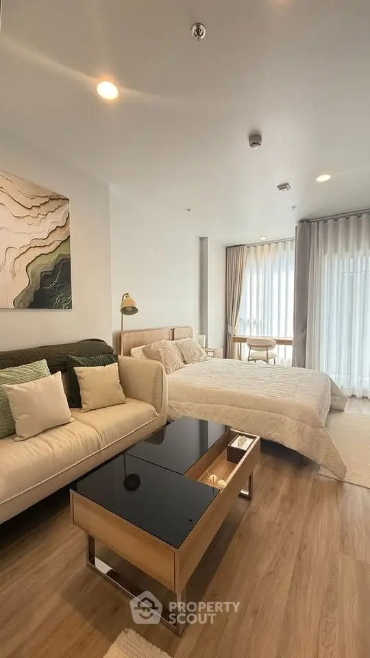 Modern studio apartment with cozy living area and natural light