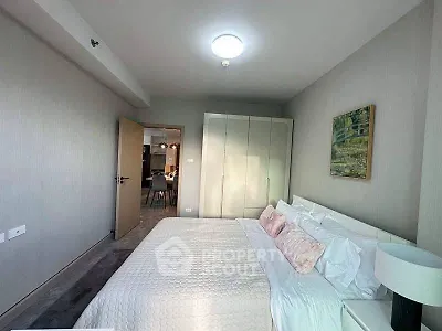 Modern bedroom with cozy bed and stylish decor in a contemporary apartment.