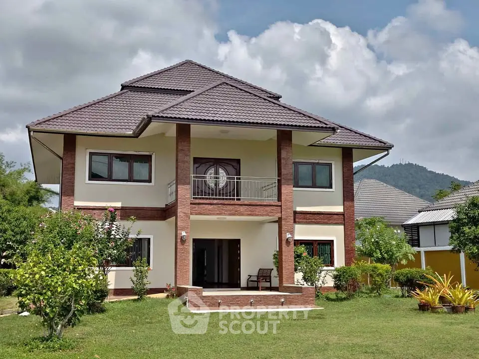 Stunning two-story house with lush garden and mountain views, perfect for serene living.