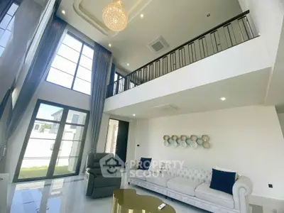 Luxurious double-height living room with elegant decor and large windows