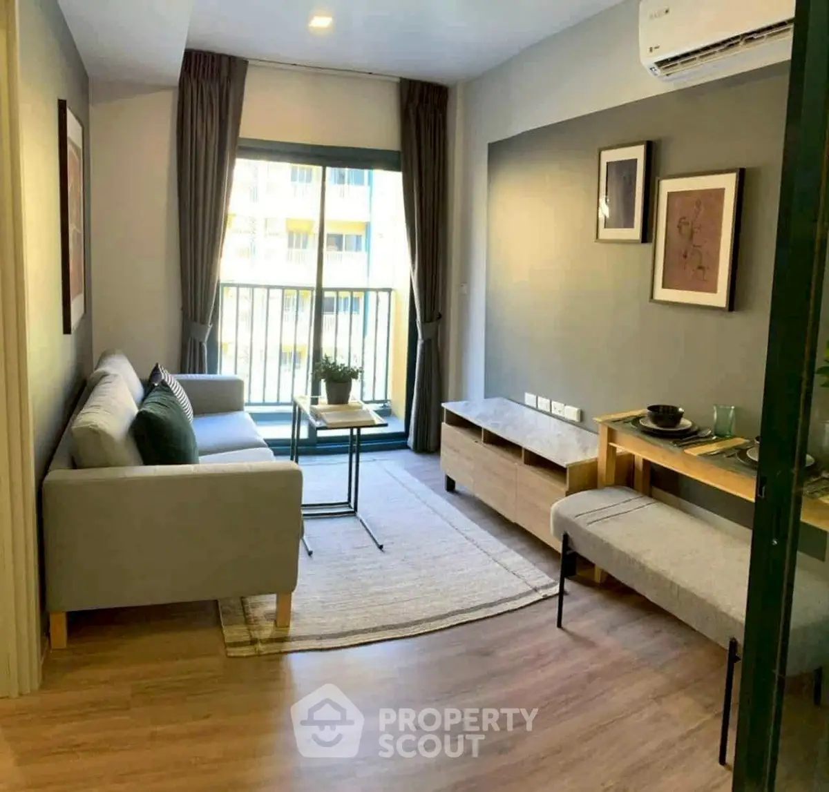 Modern living room with stylish decor and balcony view in urban apartment.