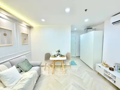 Modern living room with elegant decor and cozy dining area in a stylish apartment.