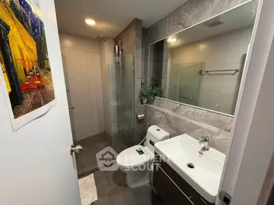 Modern bathroom with sleek fixtures and glass shower enclosure