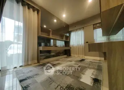 Modern living room with stylish decor and large windows for natural light.