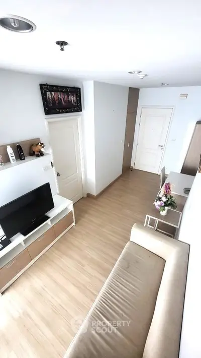 Modern living room with sleek furniture and wooden flooring