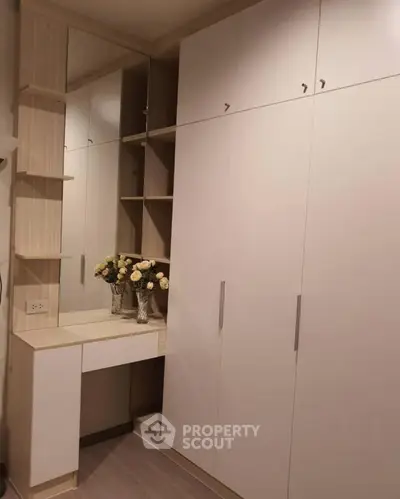 Elegant built-in wardrobe with vanity and mirror in modern bedroom