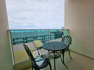 Charming balcony with city view and elegant outdoor furniture, perfect for relaxation.