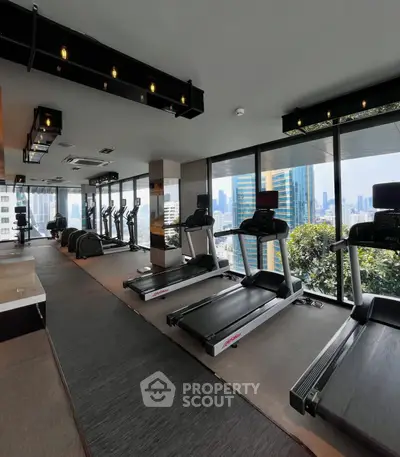 Modern gym with city view and state-of-the-art equipment in luxury high-rise building.